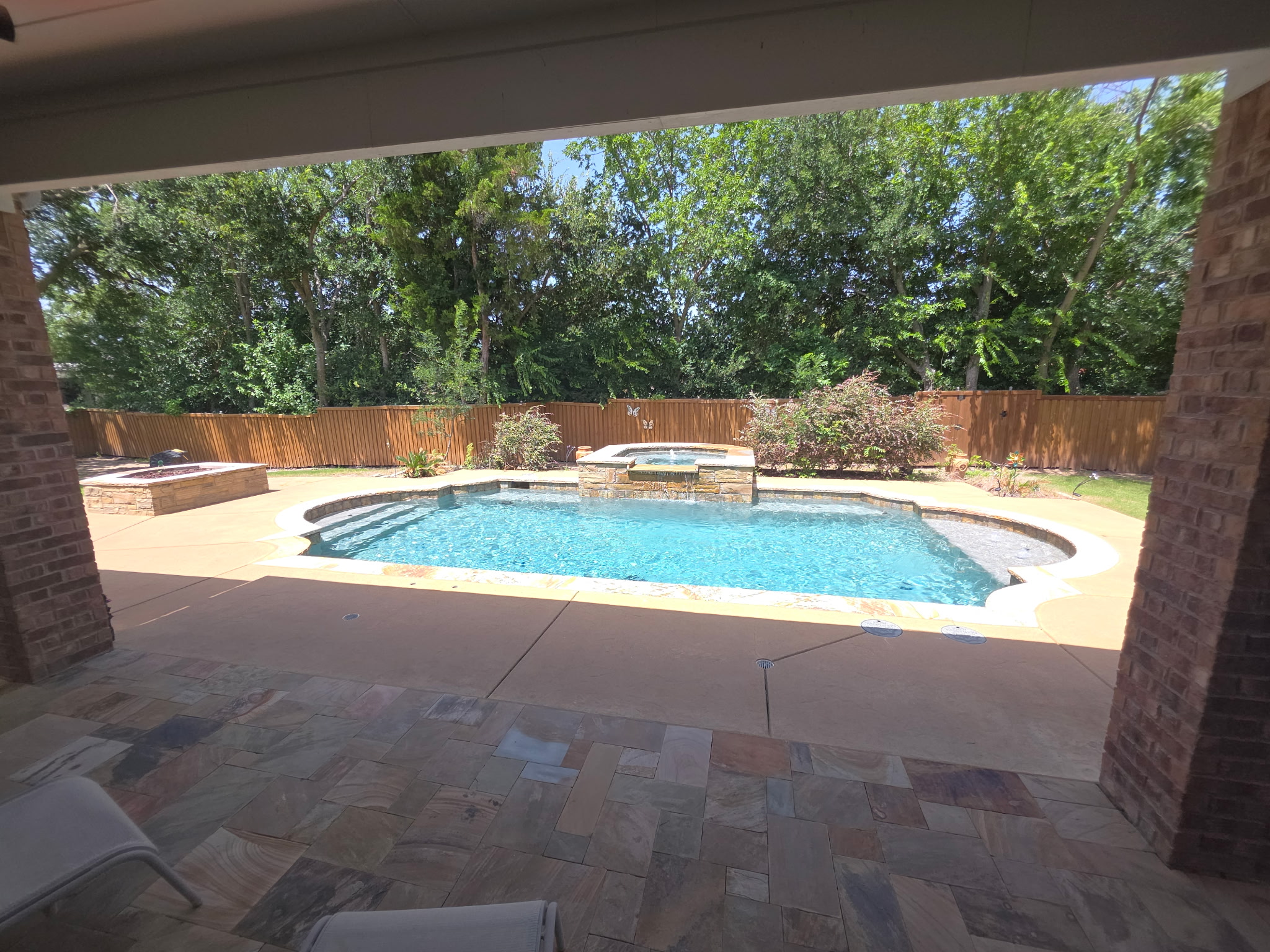 Rectangular pool with brick coping and tanning ledge, McKinney TX
