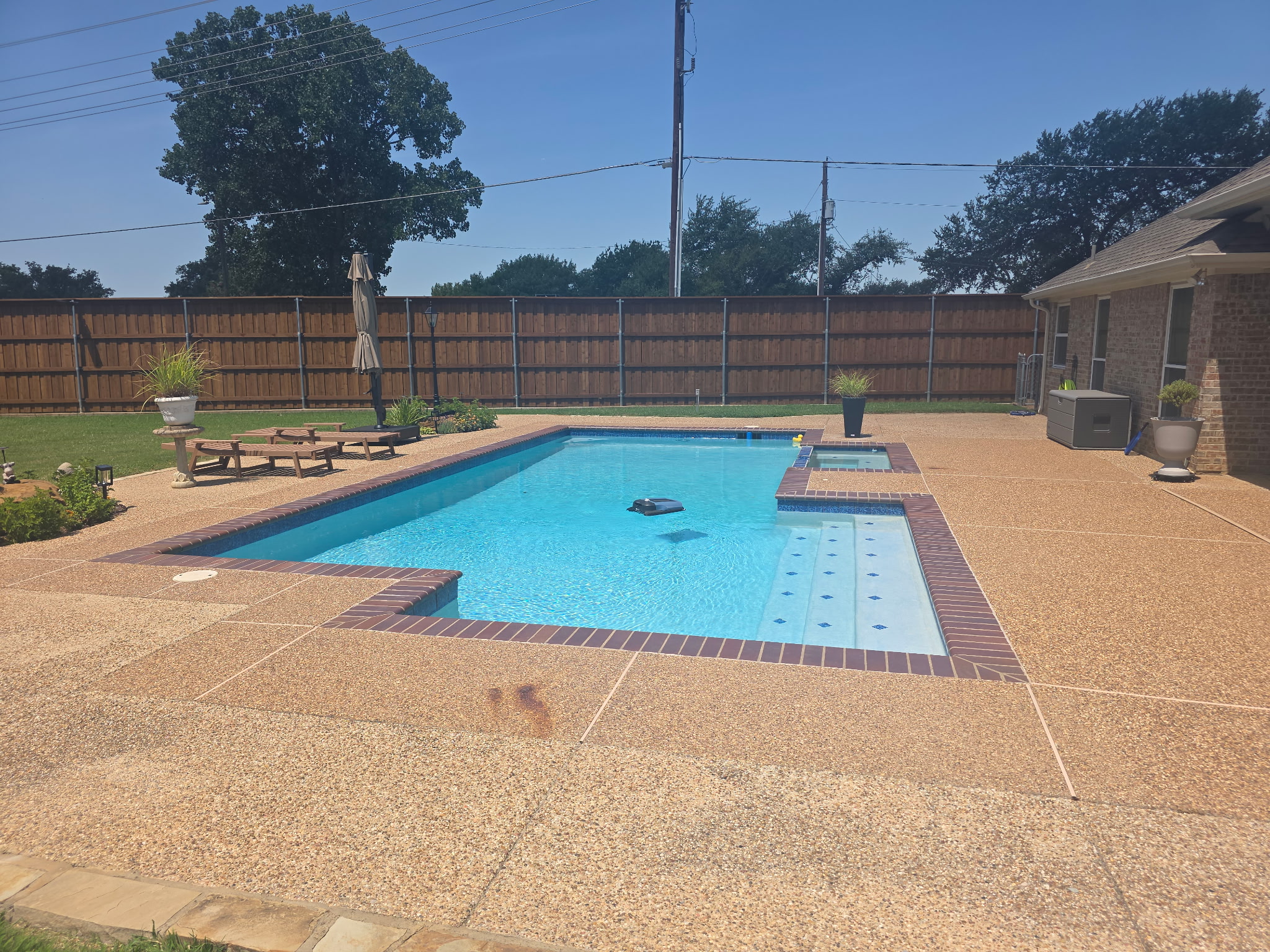 Backyard pool with raised spa and rock waterfall feature, Allen TX